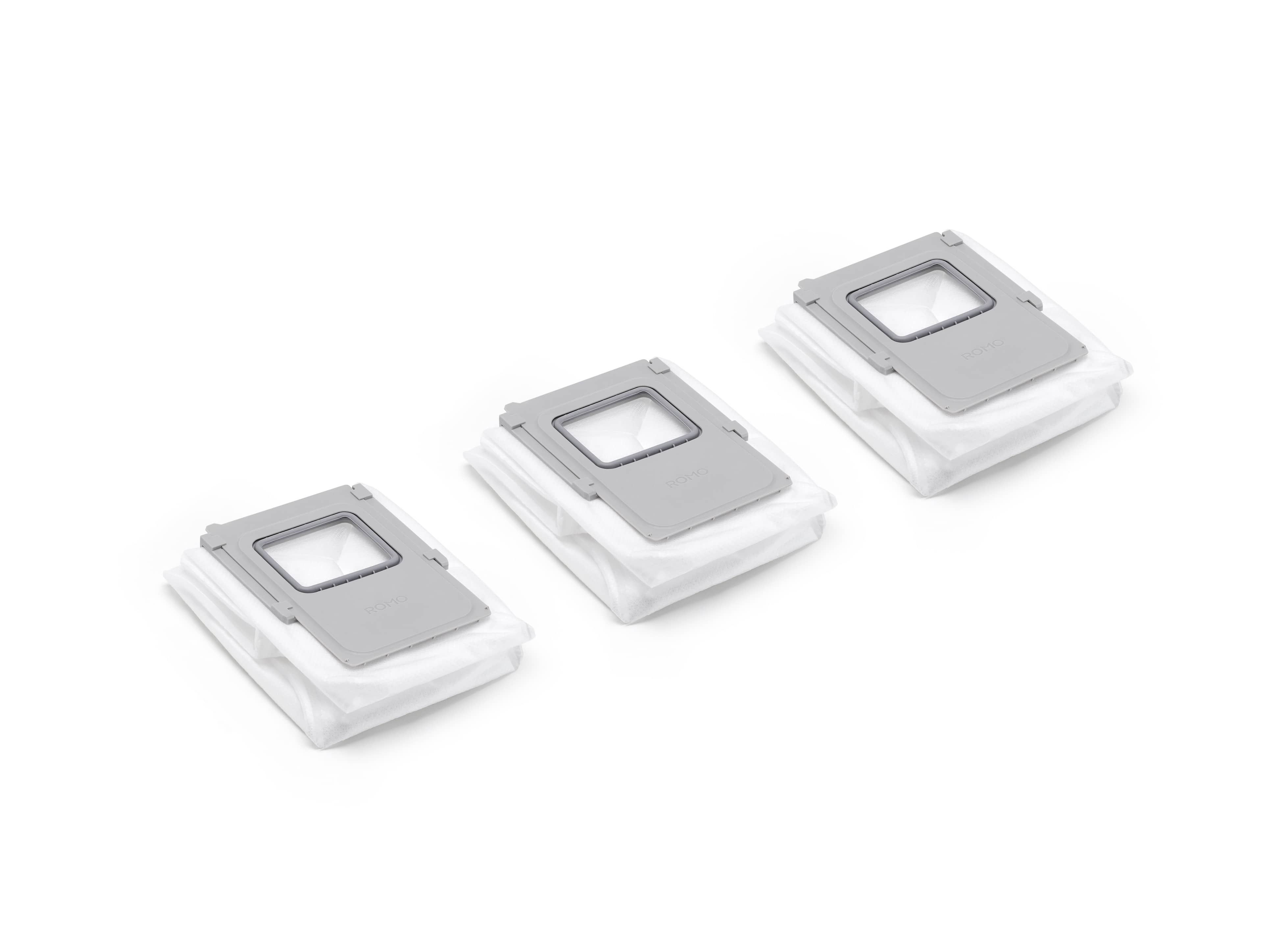 Drei DJi ROMO Basisstation Staubsäcke in weiß mit grauer Halterung für effektive Staubaufnahme.